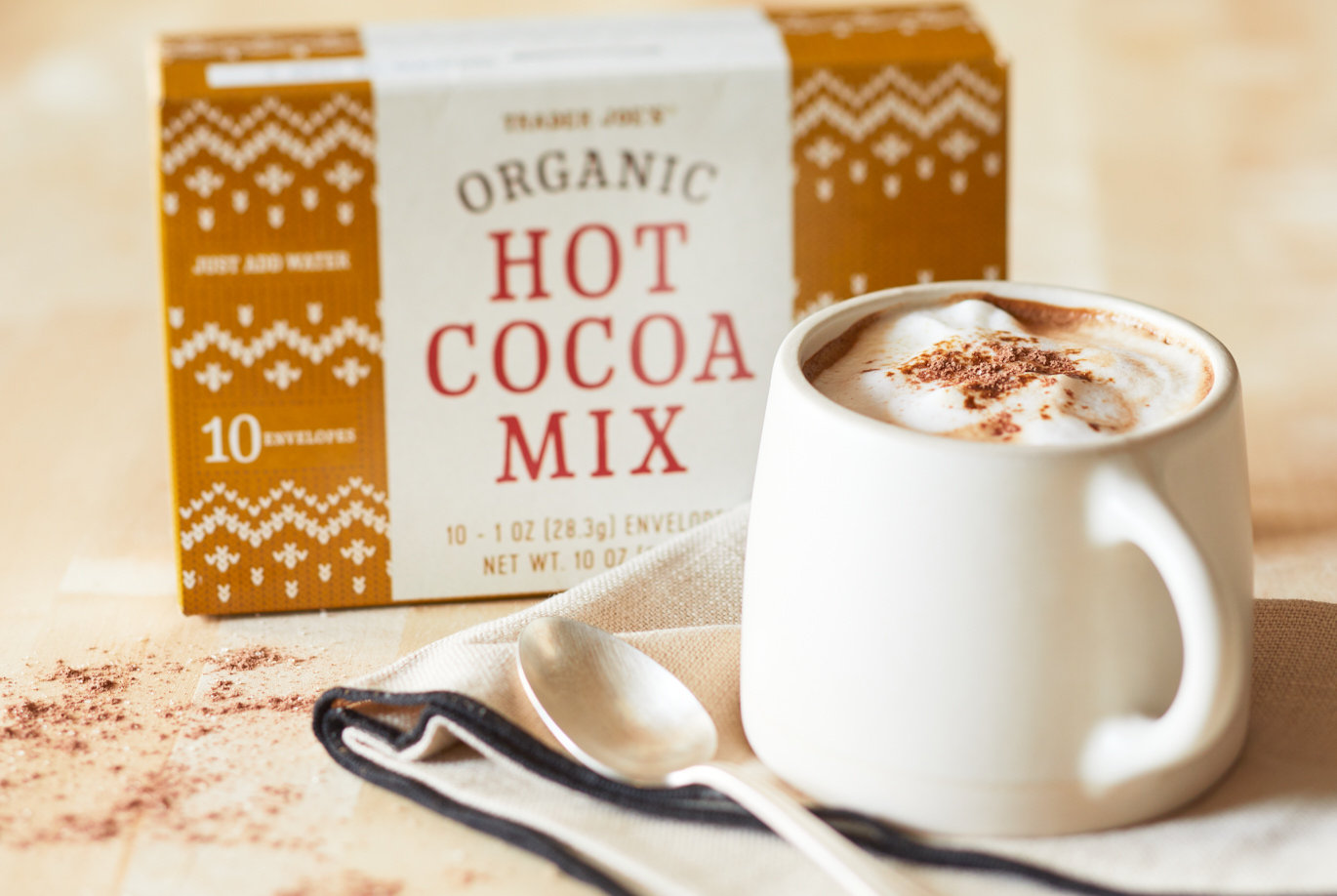 Trader Joe's Organic Hot Cocoa Mix; prepared in a white mug, with more cooca powder sprinkled on top and on surface
