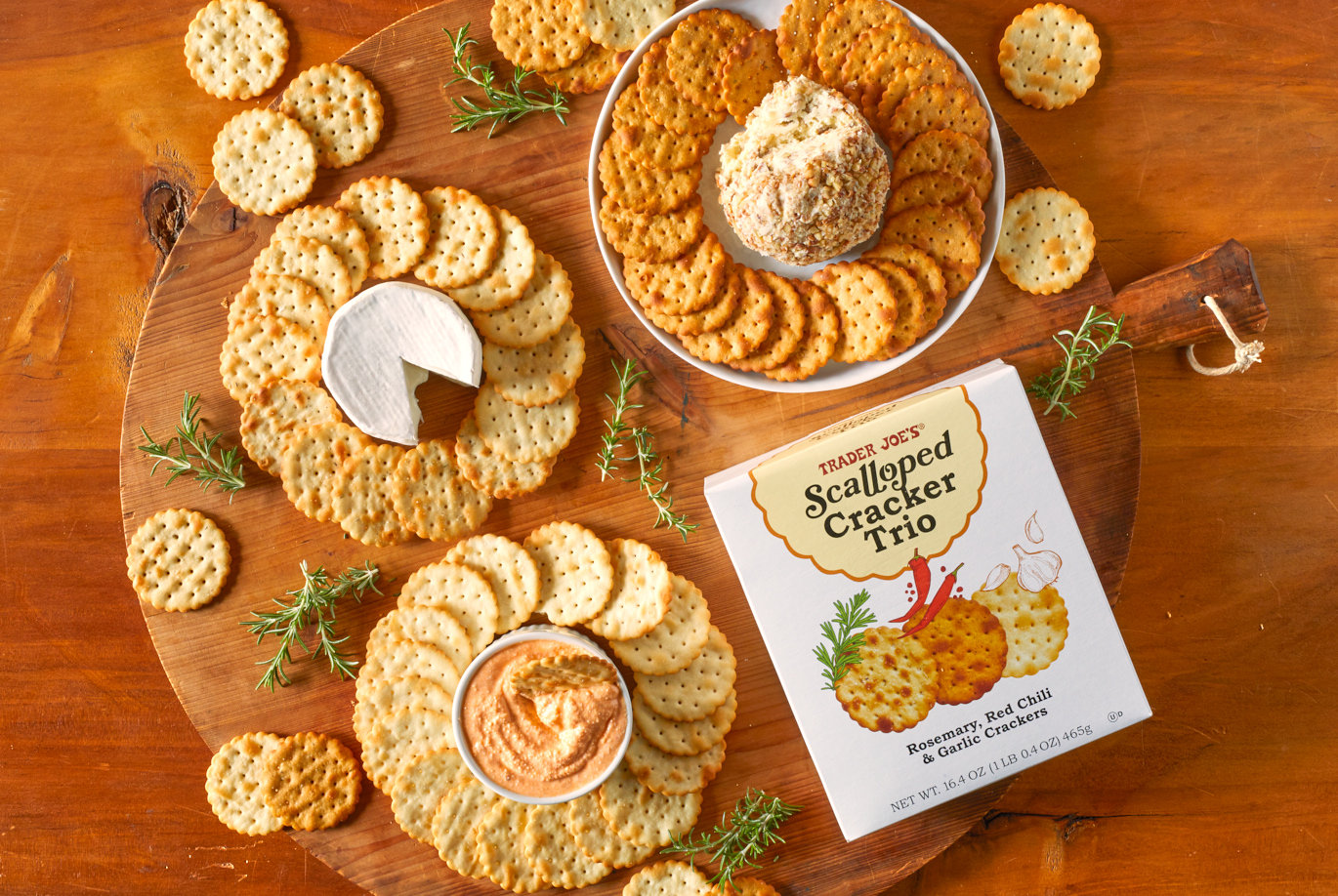 Trader Joe's Scalloped Cracker Trio; shown decorated in circles around 3 cheeses; on wood board