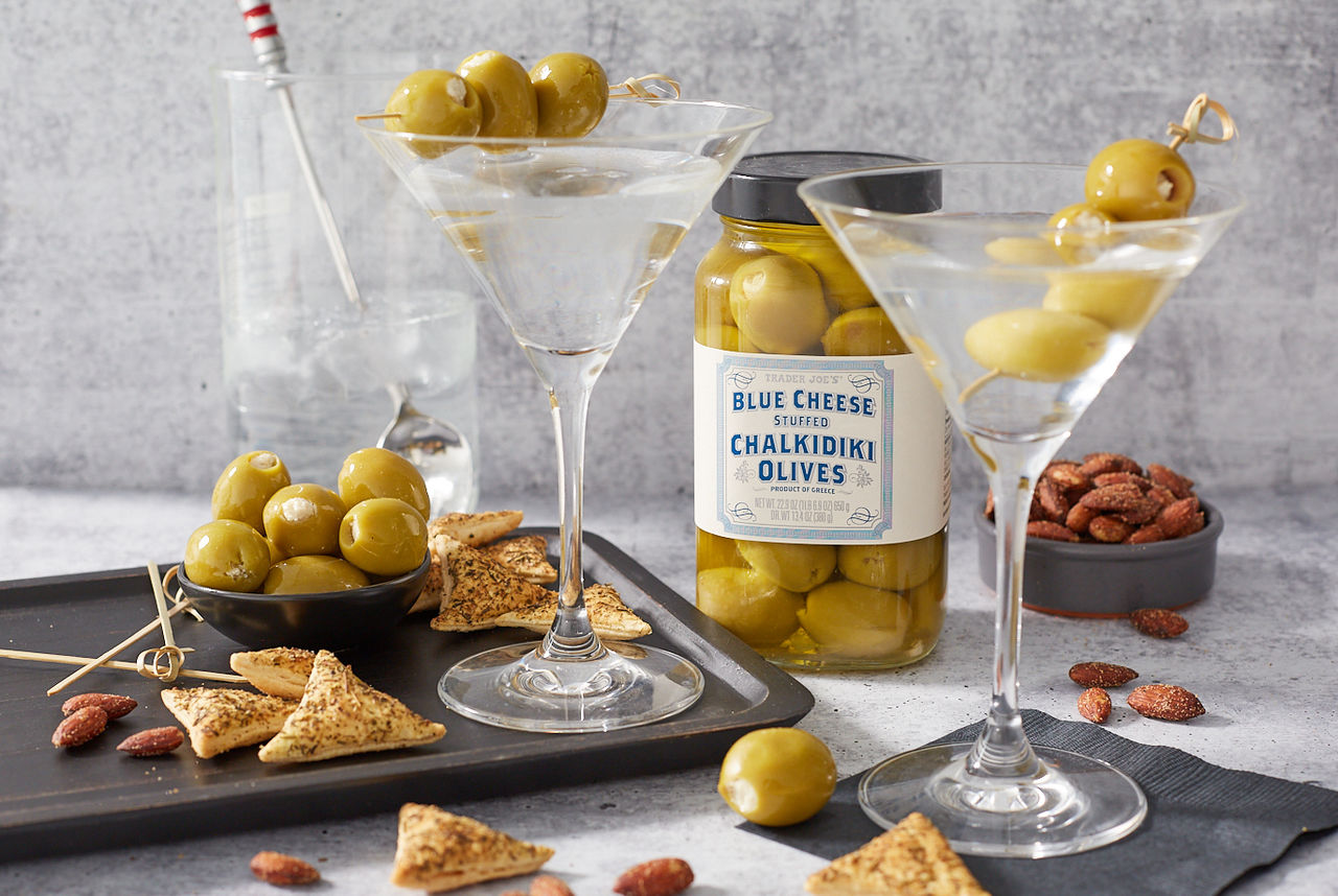 Trader Joe's Blue Cheese Stuffed Chalkidiki Olives; shown skewered and topping 2 martinis, with a small bowl of olives, nuts and crackers in background