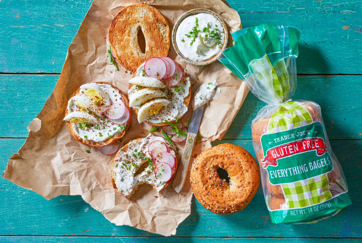 Trader Joe's Gluten Free Everything Bagels; toasted and spread with Chive & Onion Cream Cheese, and garnished with egg, radish and chives
