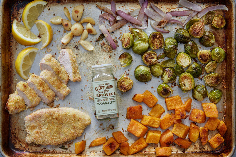 recipe: breaded turkey cutlets & roasted vegetables on a sheet pan with a bottle of Trader Joe's Everything But The Leftovers Seasoning Blend