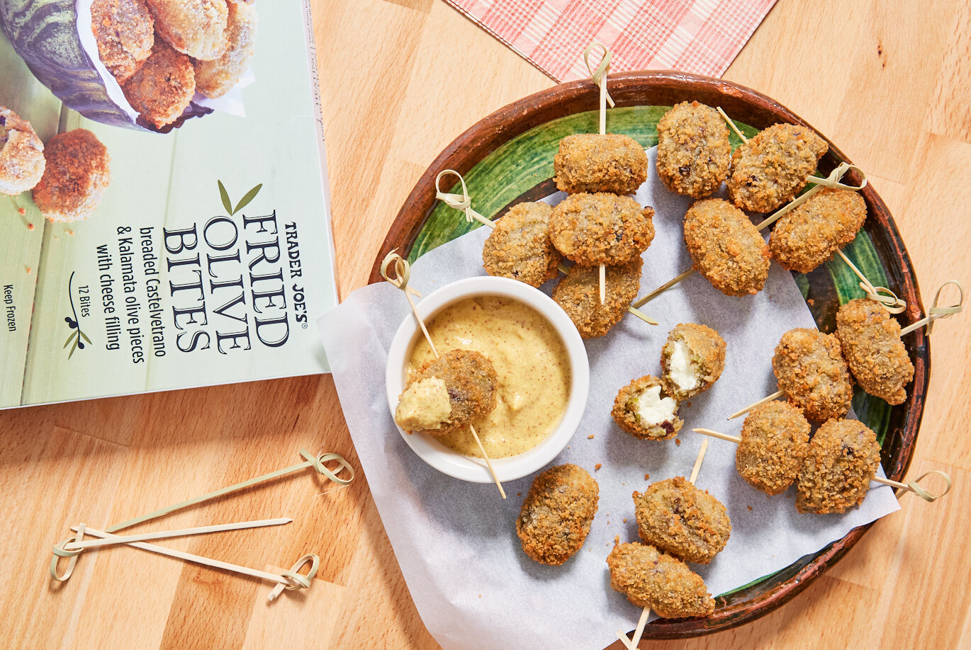 Trader Joe's Fried Olive Bites prepared and served on a plate, with aioli dipping sauce