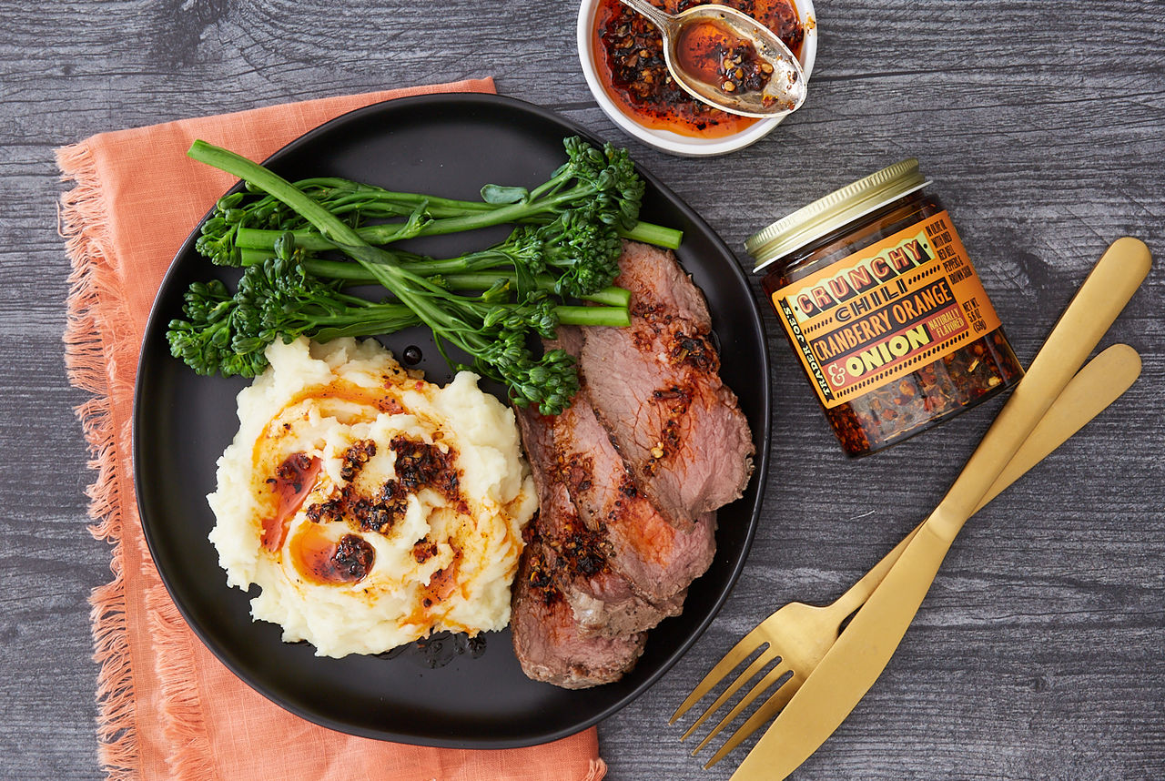 Trader Joe's Crunchy Chili Cranberry Orange & Onion, drizzled over mashed potatoes and sliced steak; with broccolini side